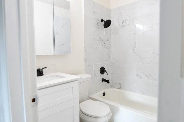 full bathroom featuring tiled shower / bath, toilet, and vanity