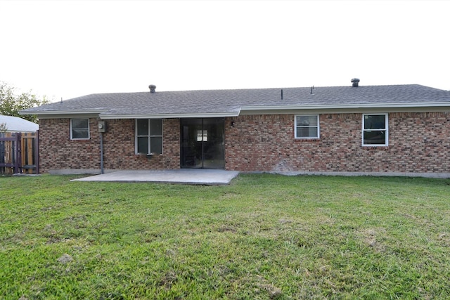 rear view of property with a lawn and a patio area