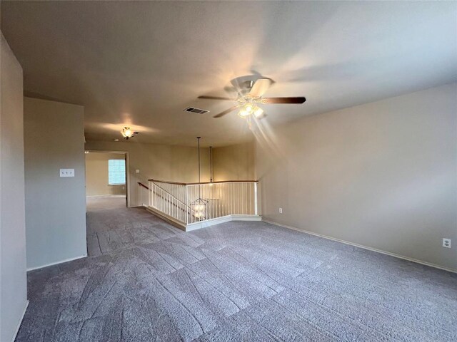 empty room featuring carpet flooring and ceiling fan