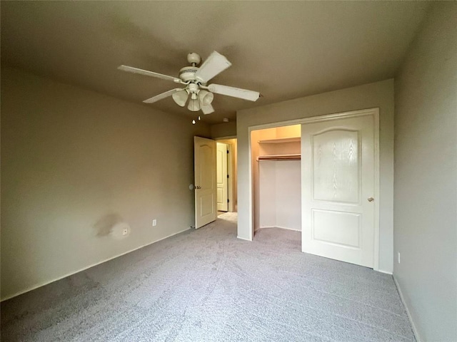 unfurnished bedroom featuring ceiling fan, a closet, and carpet floors