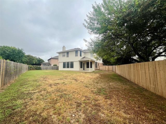 back of property featuring a lawn