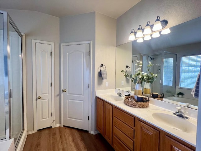 bathroom with hardwood / wood-style floors, vanity, and independent shower and bath