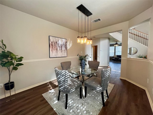 dining space with ceiling fan and dark hardwood / wood-style flooring