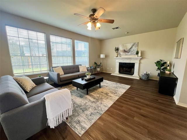 living room featuring dark hardwood / wood-style flooring and ceiling fan