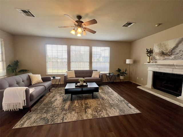 living room featuring ceiling fan and dark hardwood / wood-style flooring