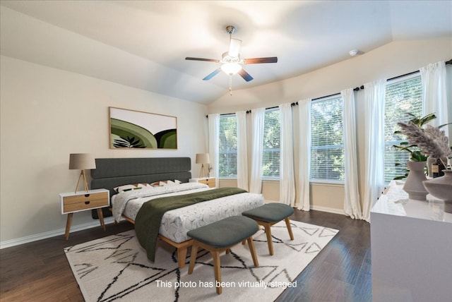 bedroom featuring lofted ceiling, dark wood-type flooring, and baseboards