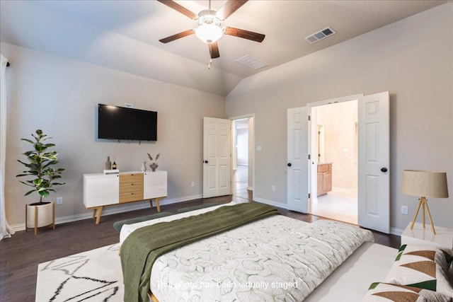 bedroom featuring vaulted ceiling, wood finished floors, visible vents, and baseboards