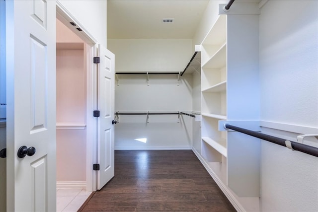 spacious closet with visible vents and wood finished floors