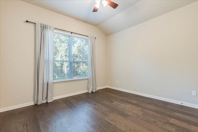 spare room featuring lofted ceiling, ceiling fan, baseboards, and dark wood finished floors