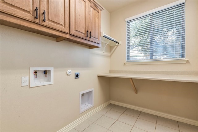 laundry room with light tile patterned floors, washer hookup, baseboards, cabinet space, and electric dryer hookup