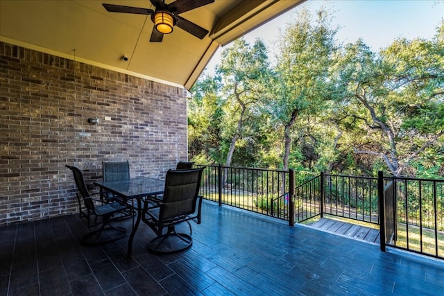 exterior space featuring a balcony, ceiling fan, and outdoor dining area