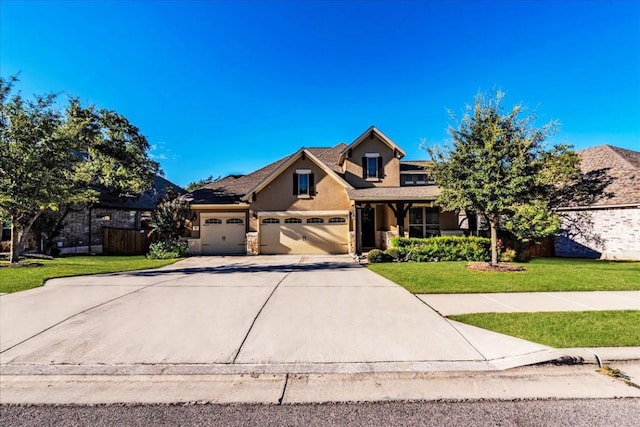 traditional home featuring stucco siding, concrete driveway, an attached garage, a front yard, and fence