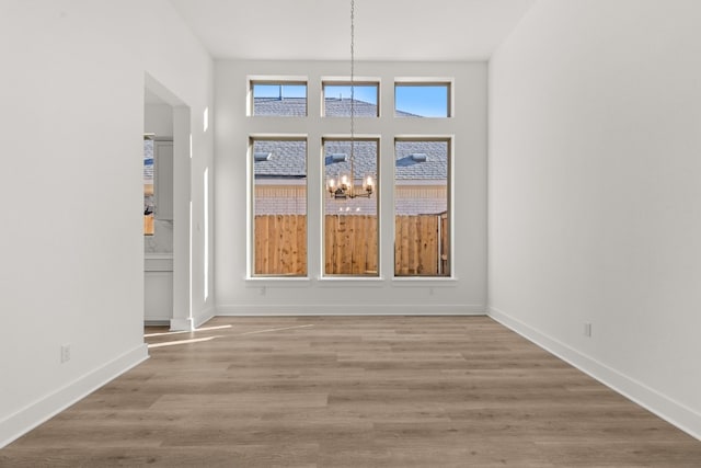 interior space with an inviting chandelier and light wood-type flooring