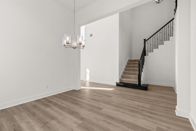 interior space featuring wood-type flooring and a notable chandelier