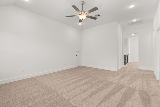 carpeted empty room featuring vaulted ceiling and ceiling fan