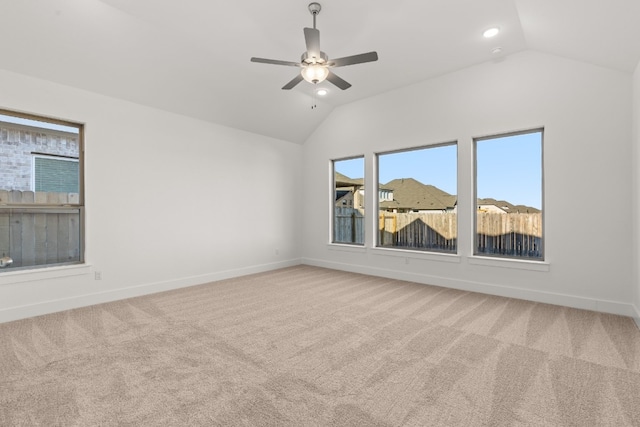 carpeted empty room featuring lofted ceiling and ceiling fan