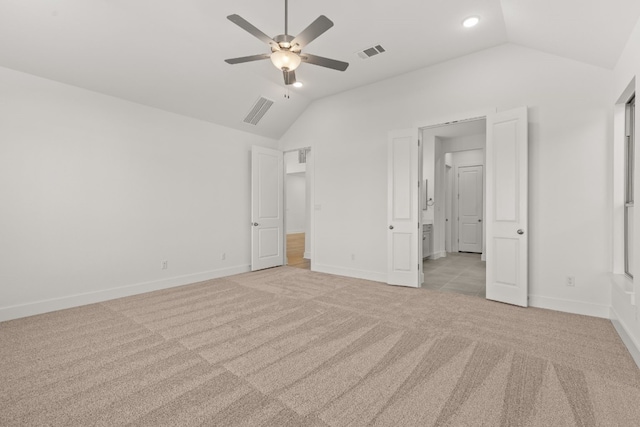 unfurnished bedroom featuring light carpet, vaulted ceiling, and ceiling fan