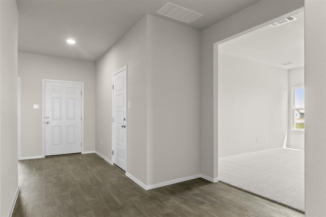 hall featuring recessed lighting, visible vents, dark wood finished floors, and baseboards