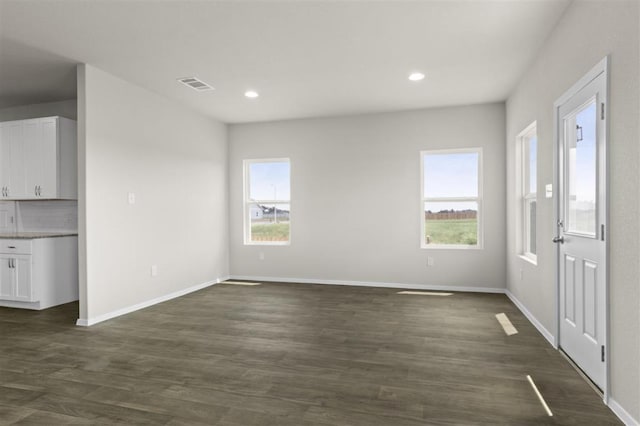 interior space featuring recessed lighting, dark wood finished floors, visible vents, and baseboards