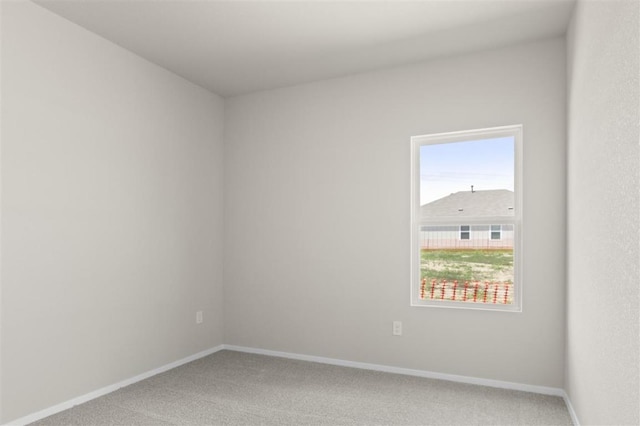 empty room with light carpet and baseboards