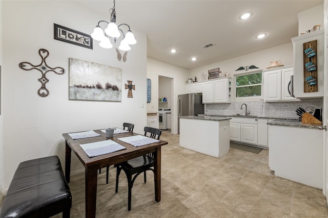 dining room with an inviting chandelier and sink