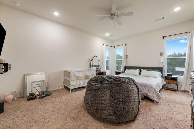 bedroom featuring ceiling fan and light colored carpet