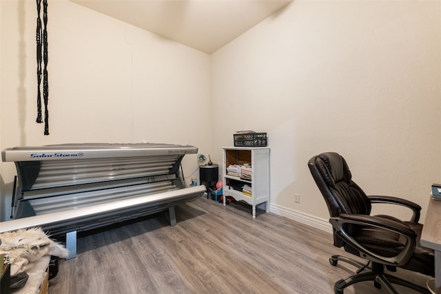 office area with light wood-type flooring and lofted ceiling