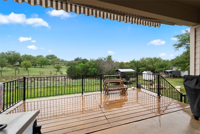 wooden terrace featuring a yard