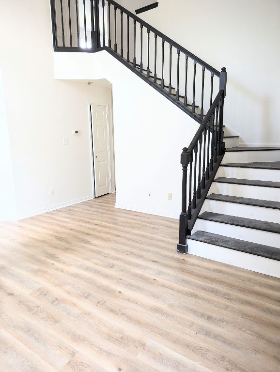 staircase with wood-type flooring