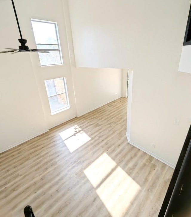 unfurnished room with light wood-type flooring and ceiling fan