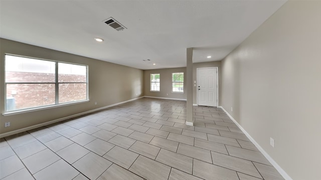 spare room featuring light tile patterned flooring