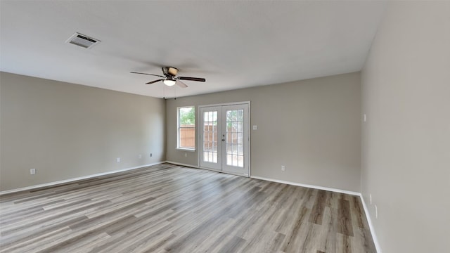 spare room with light wood-type flooring, french doors, and ceiling fan