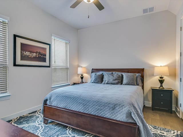 bedroom with vaulted ceiling, wood-type flooring, and ceiling fan