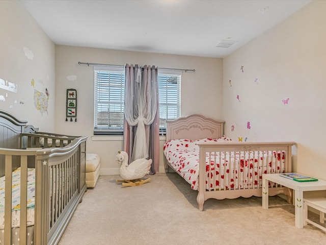 bedroom with carpet flooring and a nursery area