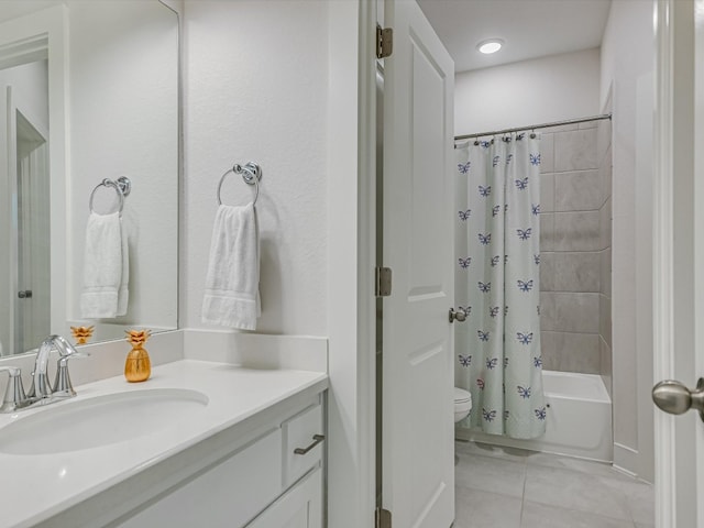 full bathroom with tile patterned flooring, vanity, toilet, and shower / bath combo with shower curtain