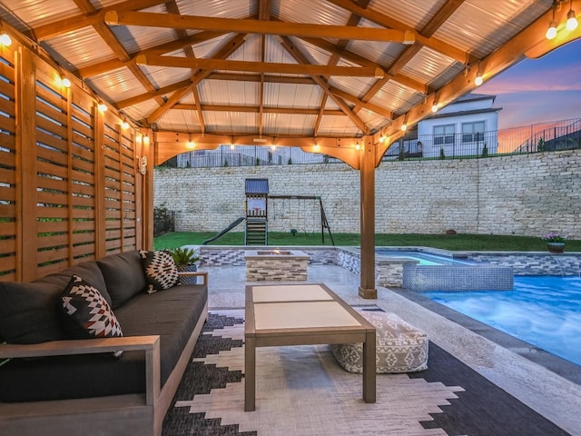 patio terrace at dusk with an outdoor living space, a gazebo, and a swimming pool with hot tub