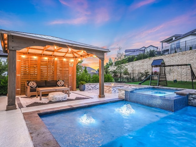 pool at dusk featuring an outdoor living space, a patio area, a gazebo, an in ground hot tub, and a playground