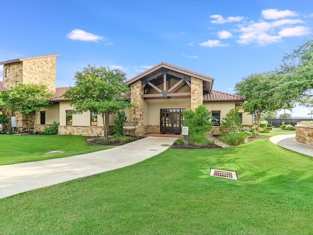 view of front of house with french doors and a front yard