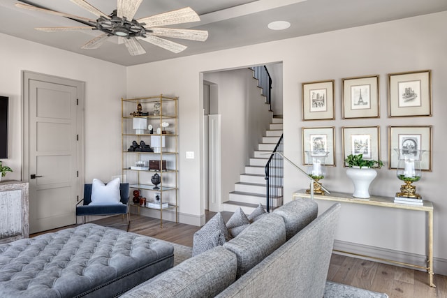 living room with wood-type flooring and ceiling fan