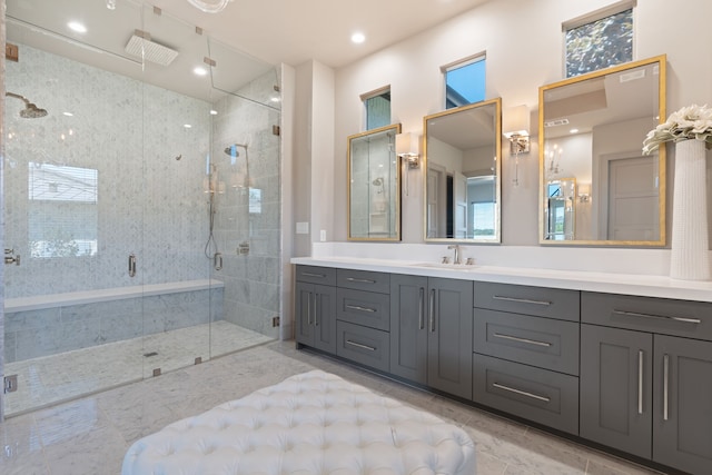 bathroom with a shower with door and vanity