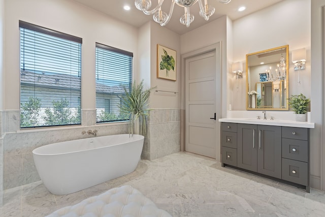 bathroom featuring a healthy amount of sunlight, a tub to relax in, and tile walls