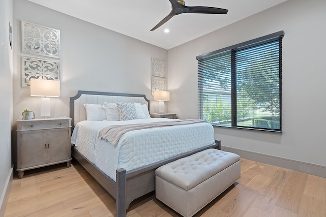 bedroom with ceiling fan and light hardwood / wood-style flooring