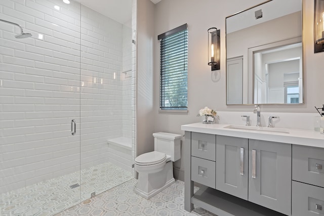 bathroom with vanity, toilet, walk in shower, and tile patterned floors