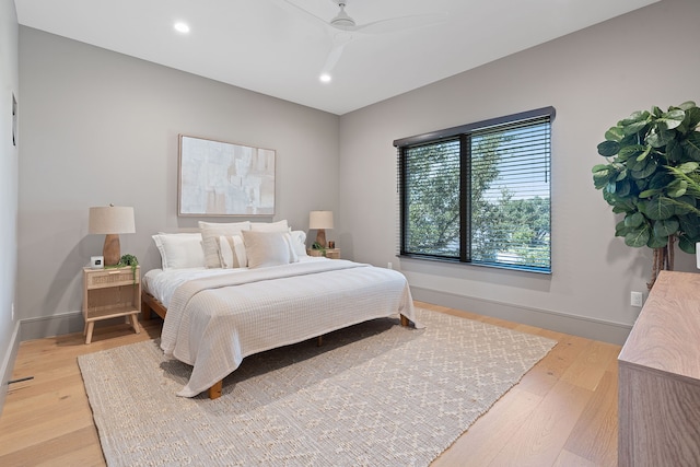 bedroom with ceiling fan and light hardwood / wood-style floors