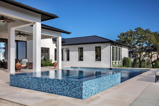 view of pool with ceiling fan and a patio area