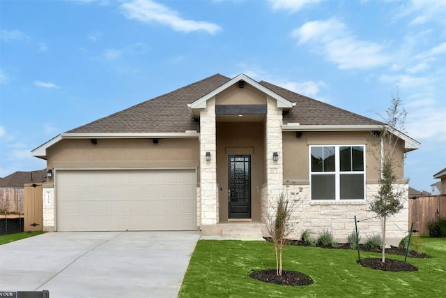 view of front of house featuring a front lawn and a garage