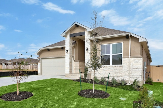 view of front of property with a garage and a front lawn