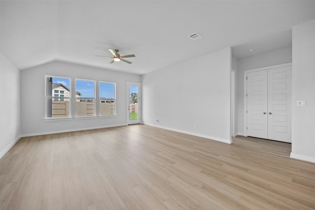 unfurnished living room with ceiling fan, light hardwood / wood-style floors, and lofted ceiling