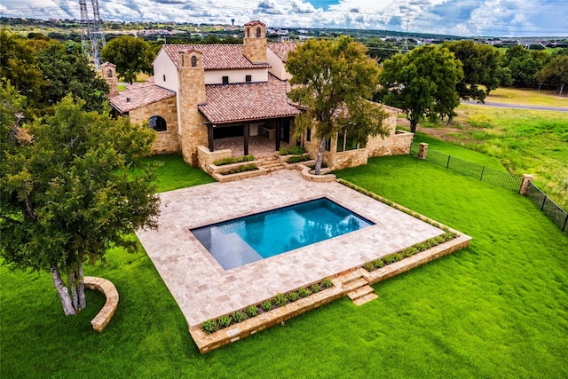 view of swimming pool with a lawn and a patio