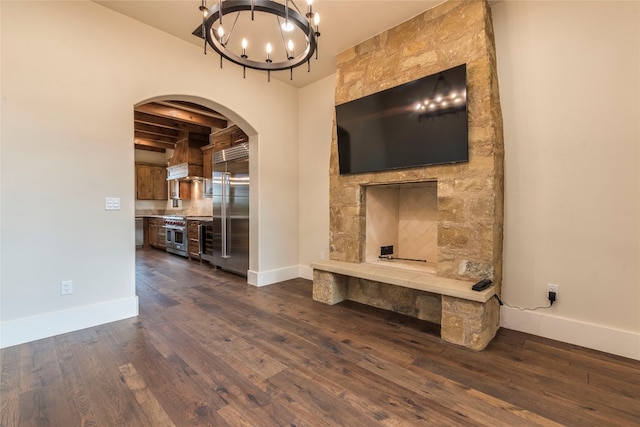 unfurnished living room featuring beamed ceiling, dark hardwood / wood-style floors, and a notable chandelier